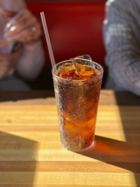 a drink sitting on top of a wooden table