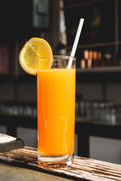 orange juice in clear drinking glass