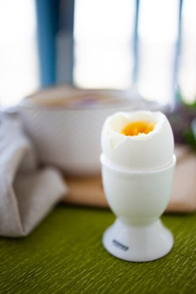 white ceramic egg figurine on green table