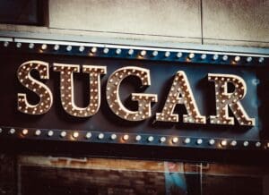 a sign that says sugar on the side of a building