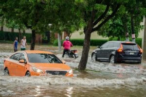 A group of people walking through a flooded street