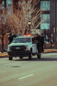 Swat team riding in a truck with guns.